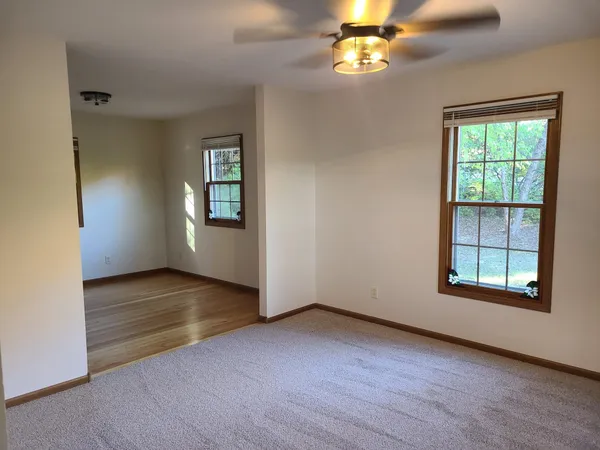 an empty room with windows and closet