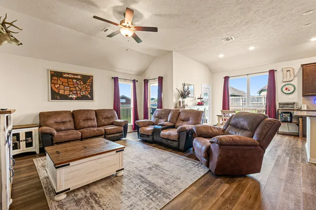 a living room with furniture ceiling fan and a rug