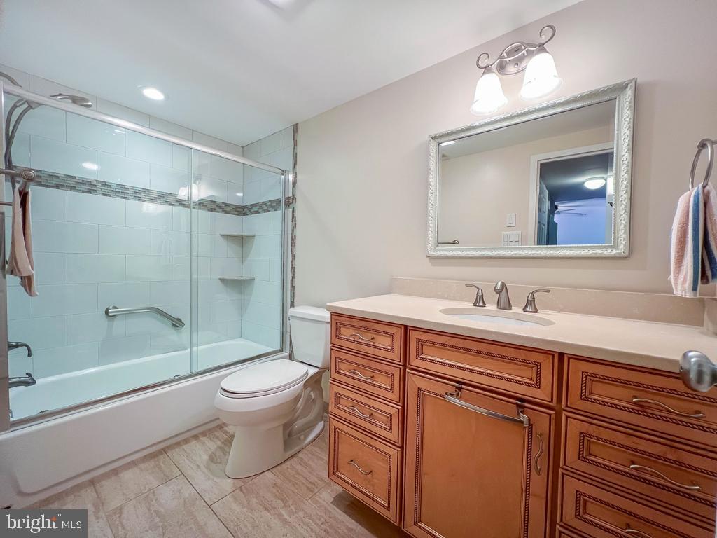 6204 Delaire Landing Road, Unit 204 Philadelphia, PA 19114 - Photo 21 of 40 a bathroom with a granite countertop sink toilet and shower
