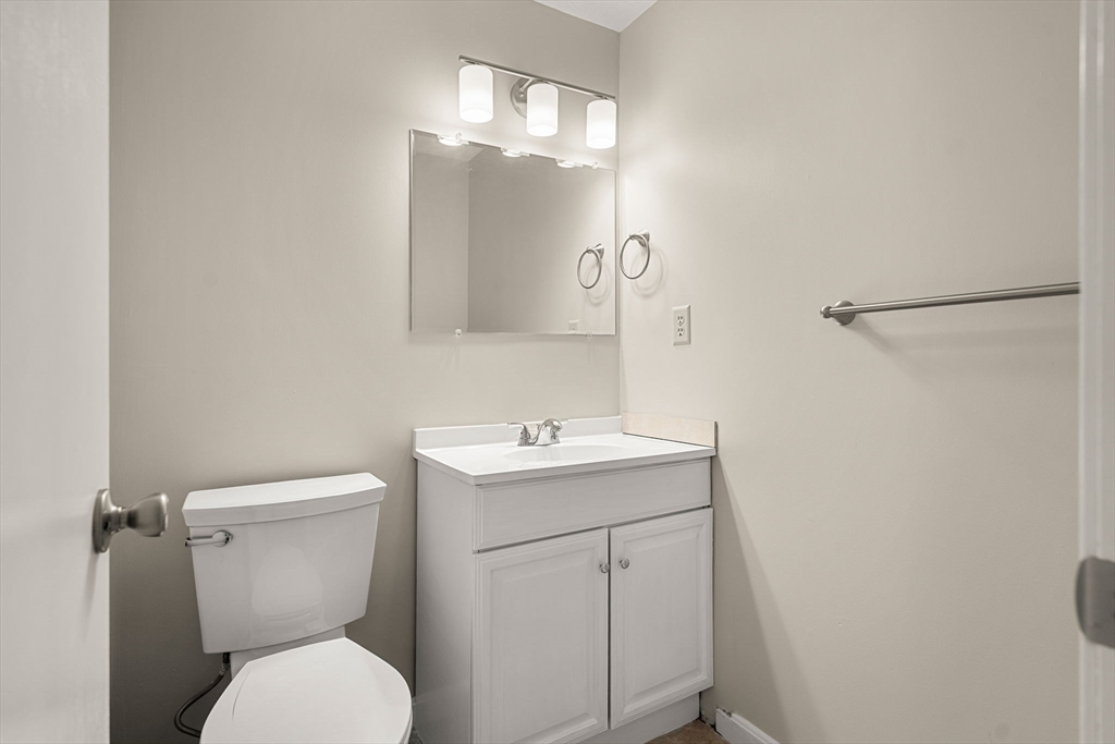 290 Apache Way, Unit 290 Tewksbury, MA 01876 - Photo 14 of 29 a bathroom with a toilet sink and mirror