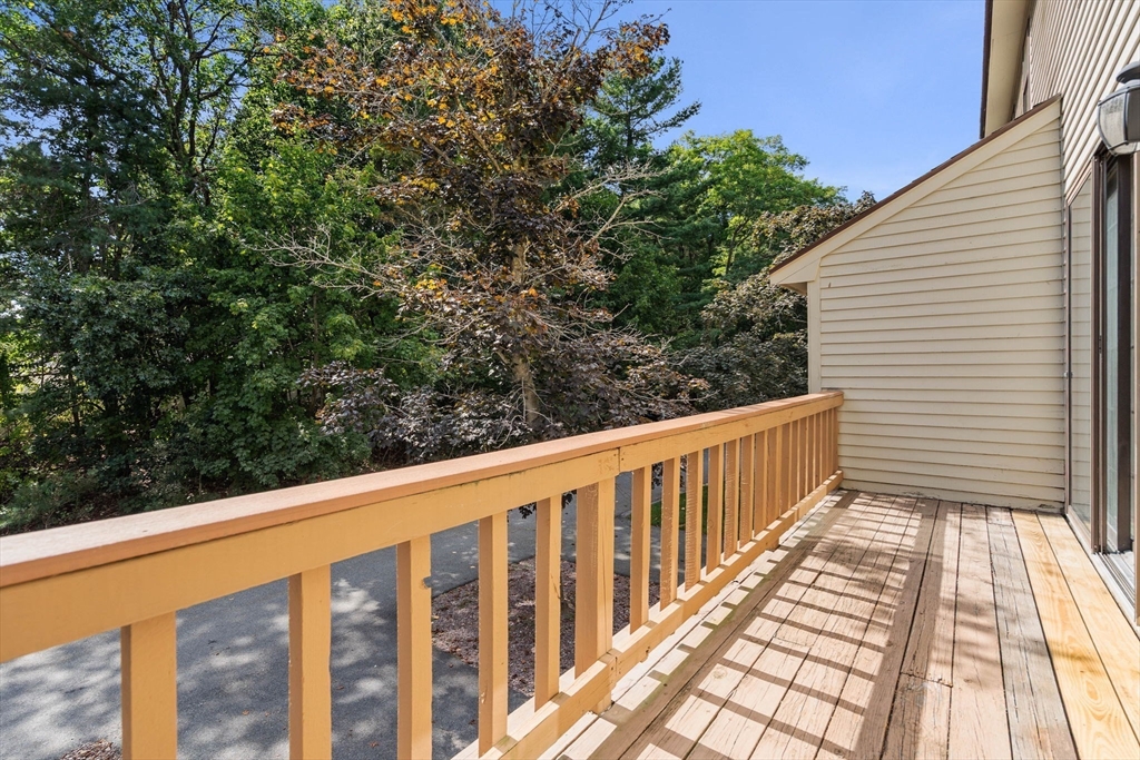 290 Apache Way, Unit 290 Tewksbury, MA 01876 - Photo 16 of 29 a balcony with an outdoor space