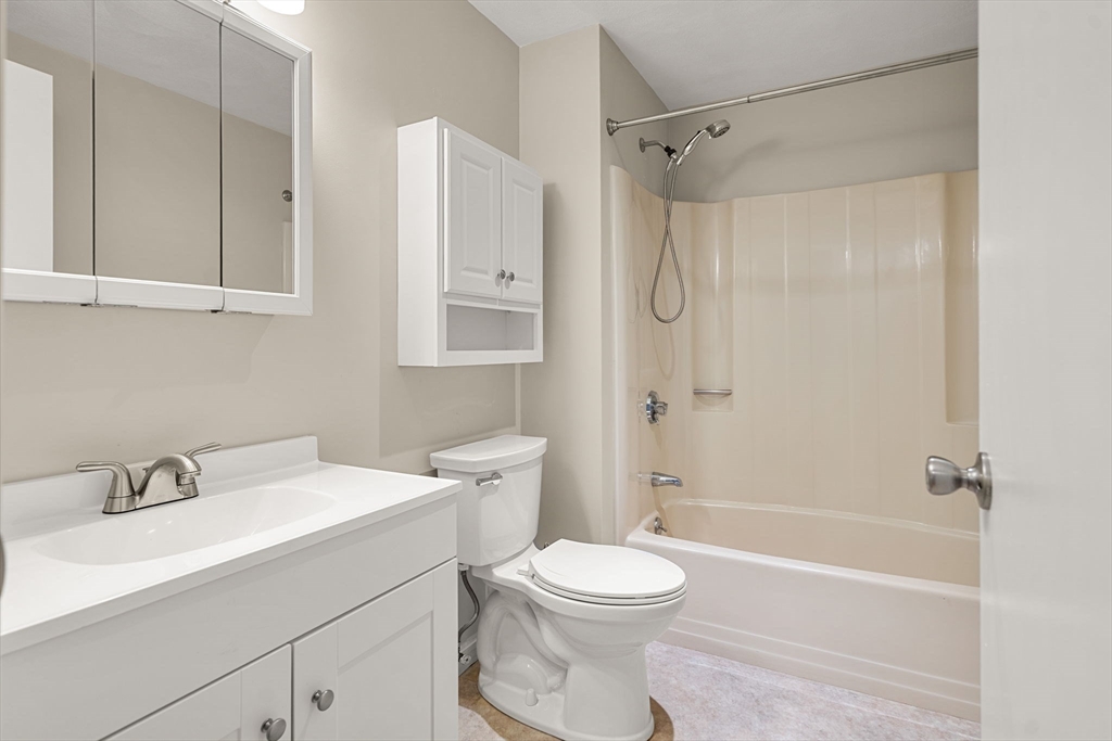 290 Apache Way, Unit 290 Tewksbury, MA 01876 - Photo 17 of 29 a bathroom with a sink a toilet and shower