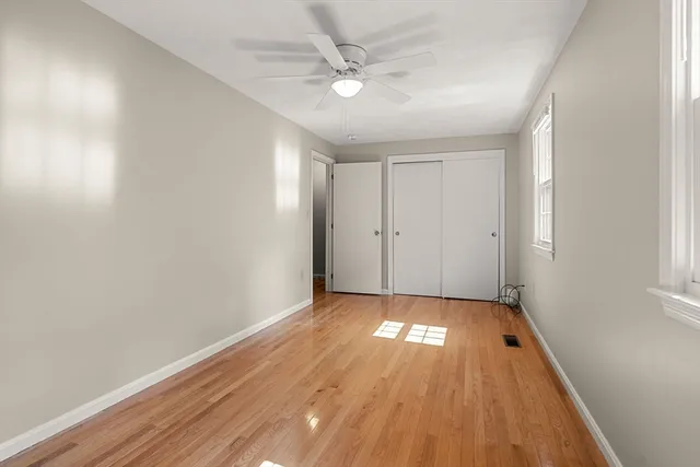 wooden floor in an empty room with a window