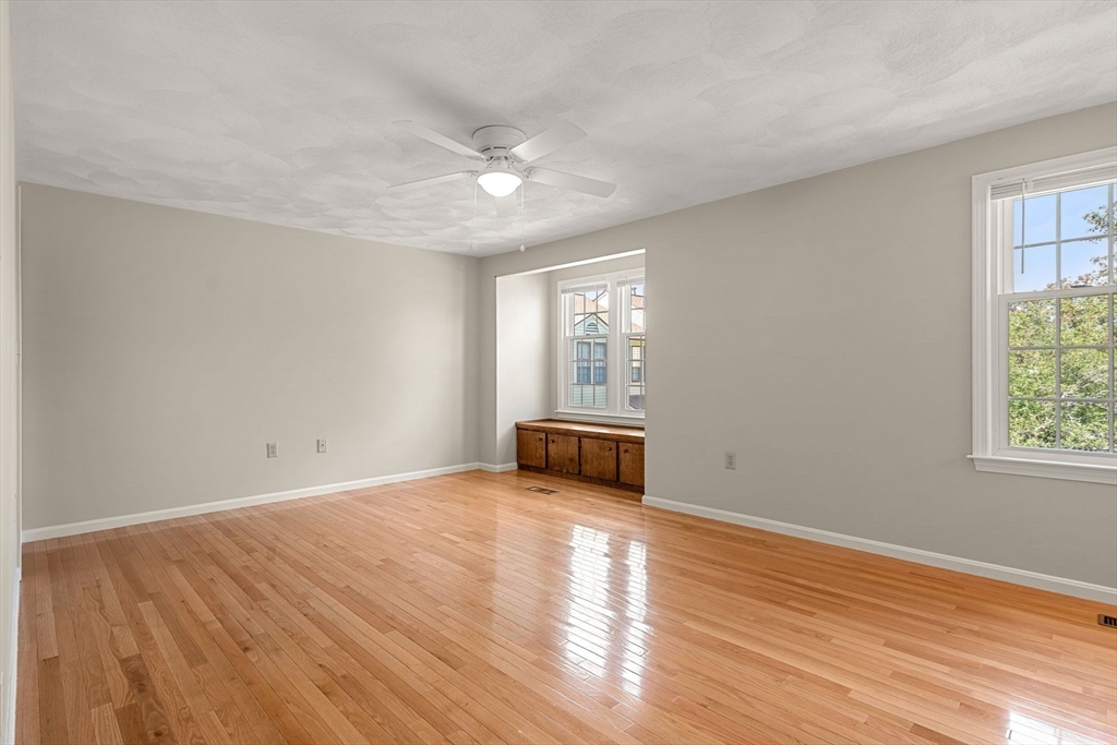 290 Apache Way, Unit 290 Tewksbury, MA 01876 - Photo 19 of 29 an empty room with wooden floor and windows