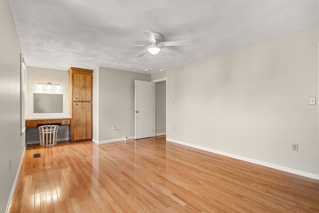 290 Apache Way, Unit 290 Tewksbury, MA 01876 - Photo 20 of 29 wooden floor in an empty room with a window