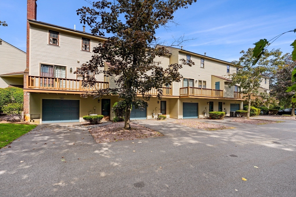 290 Apache Way, Unit 290 Tewksbury, MA 01876 - Photo 2 of 29 a front view of a house with yard and parking