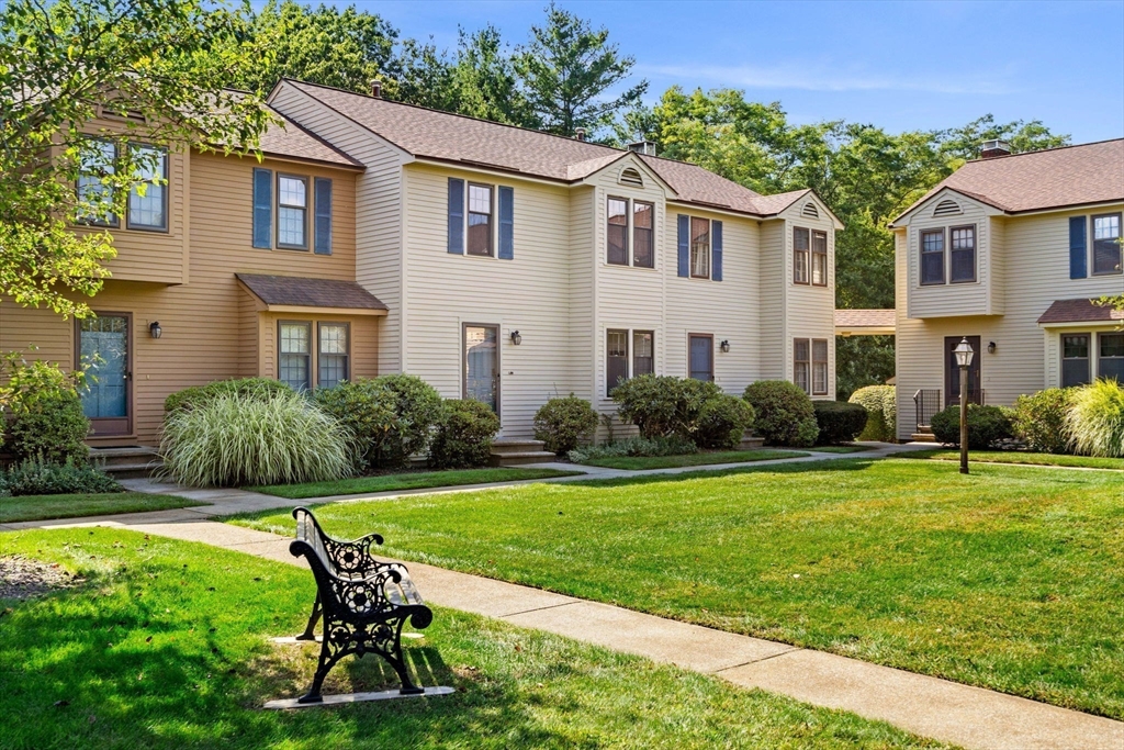 290 Apache Way, Unit 290 Tewksbury, MA 01876 - Photo 22 of 29 a view of a house with a yard chairs and table in patio