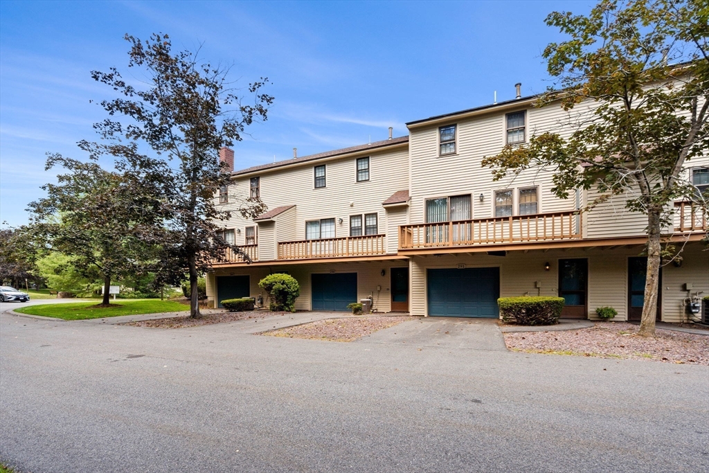 290 Apache Way, Unit 290 Tewksbury, MA 01876 - Photo 24 of 29 a view of a house with a yard and large tree