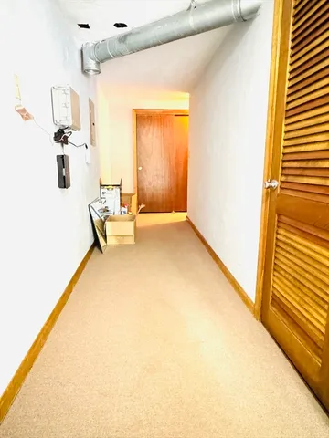 a hallway with a couch and chandelier