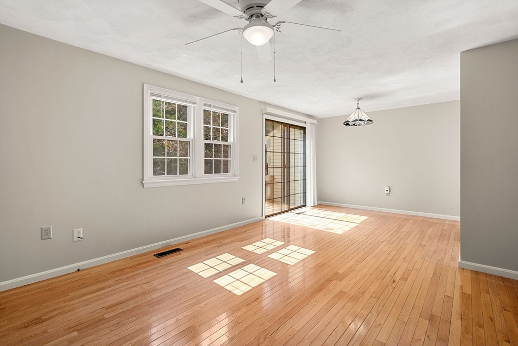 290 Apache Way, Unit 290 Tewksbury, MA 01876 - Photo 3 of 29 a view of empty room with wooden floor and fan