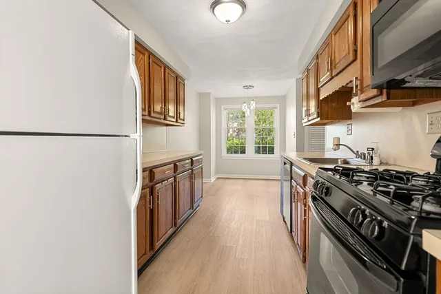 a kitchen with stainless steel appliances a stove a sink and a refrigerator