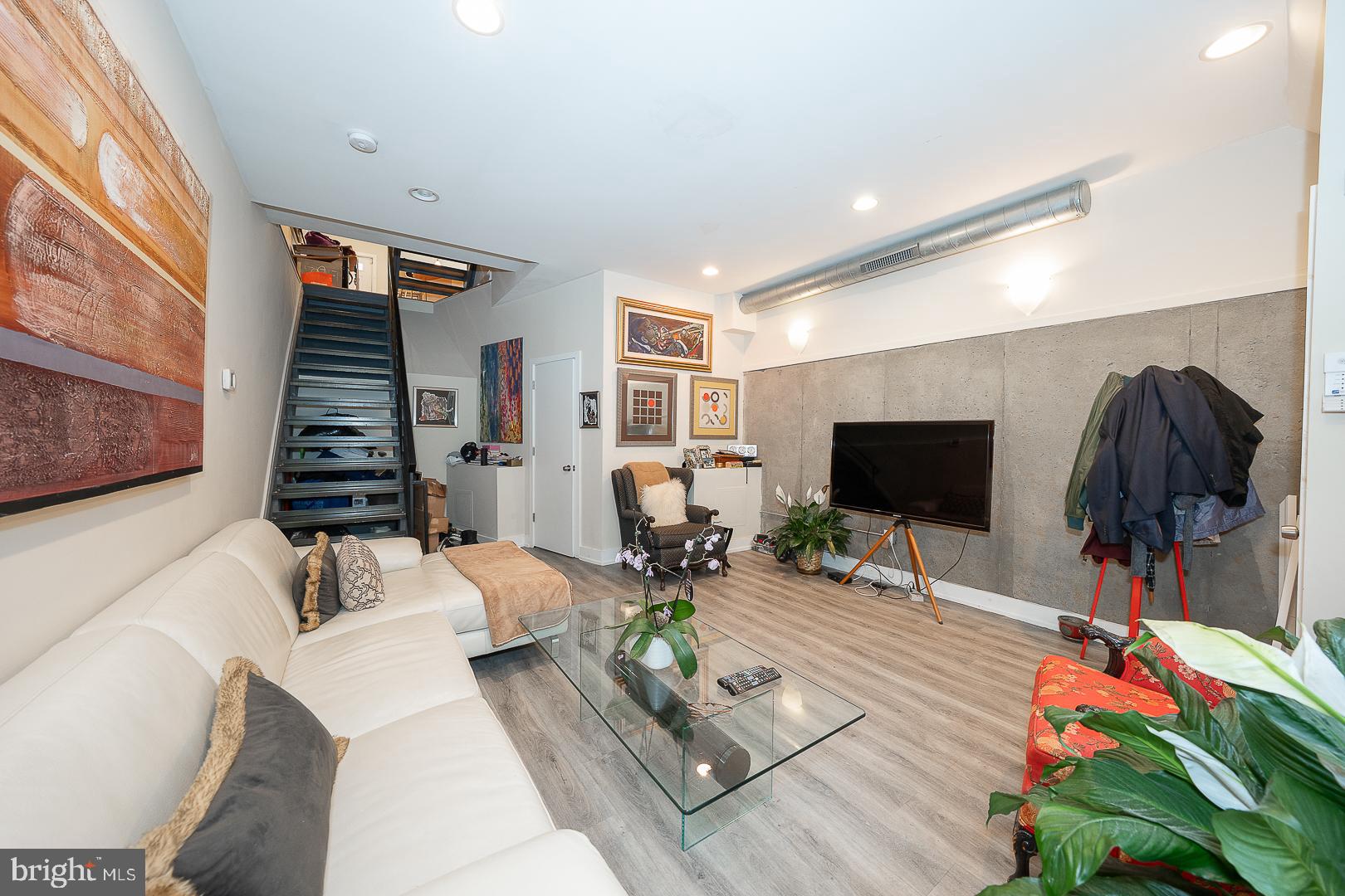 715 Shirley Street, Unit A Philadelphia, PA 19130 - Photo 2 of 24 a living room with furniture and a flat screen tv