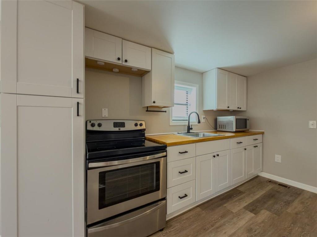 2317 Ford White Road Gainesville, GA 30506 - Photo 13 of 27 a kitchen with granite countertop cabinets stainless steel appliances and a sink