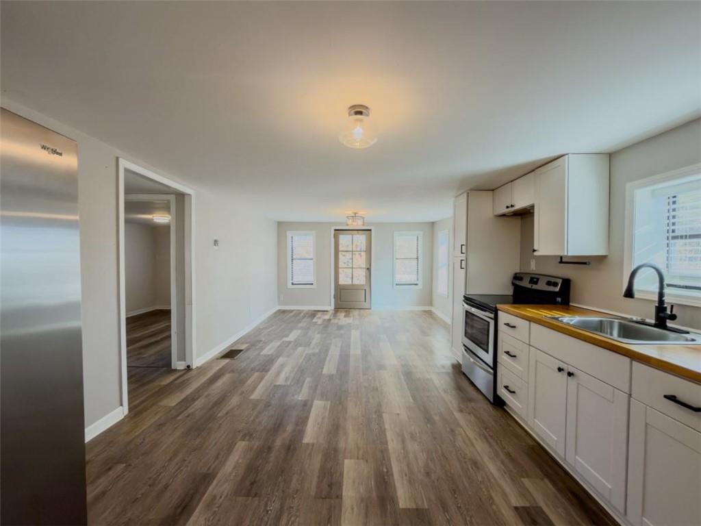 2317 Ford White Road Gainesville, GA 30506 - Photo 14 of 27 a view of a kitchen from the hallway with a large window and wooden floor