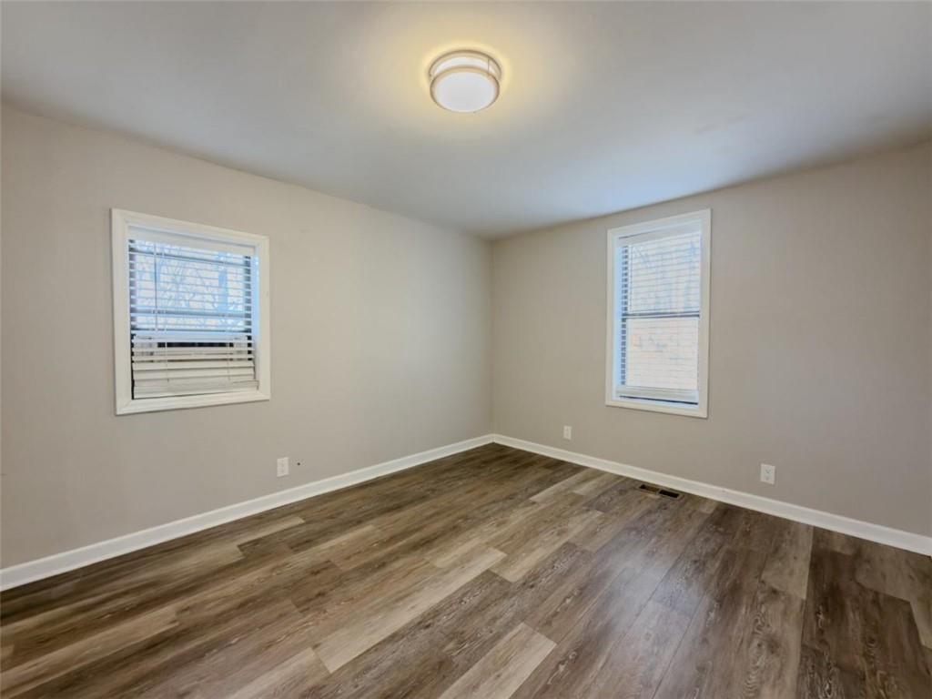 2317 Ford White Road Gainesville, GA 30506 - Photo 15 of 27 wooden floor in an empty room with a window