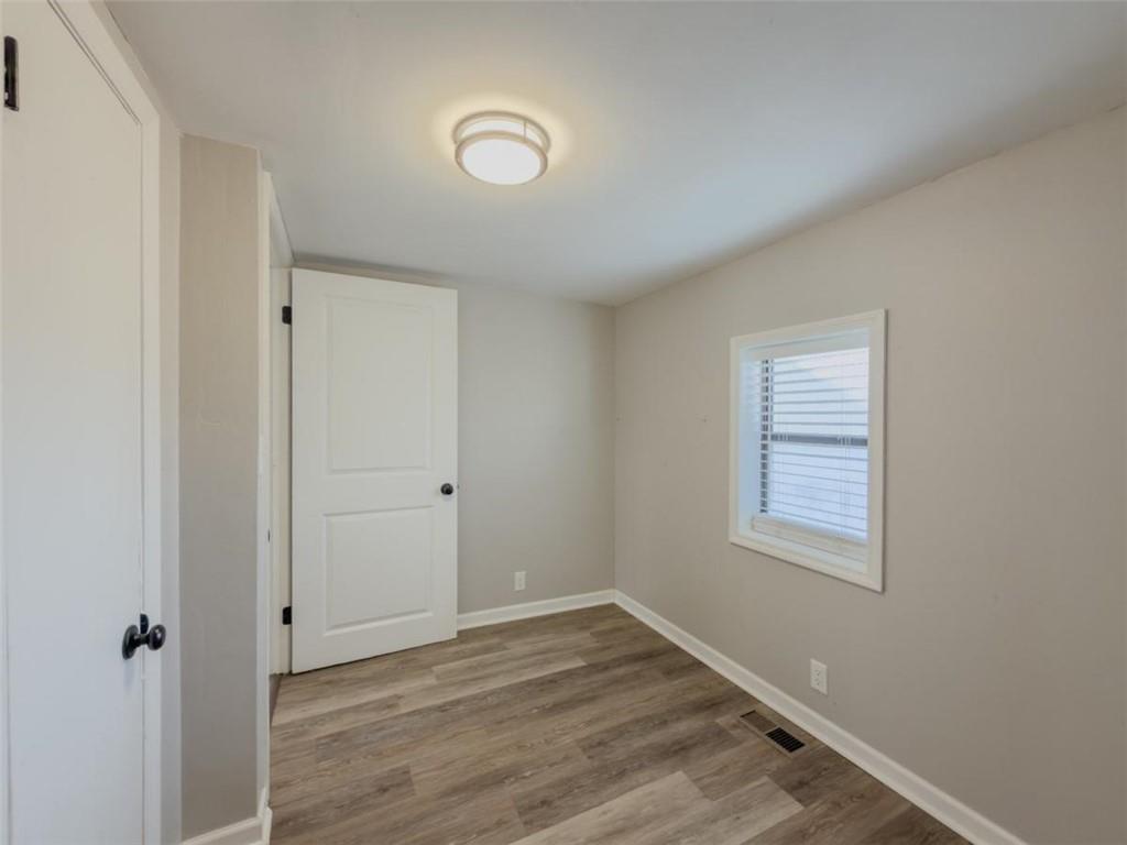2317 Ford White Road Gainesville, GA 30506 - Photo 18 of 27 an empty room with wooden floor and window