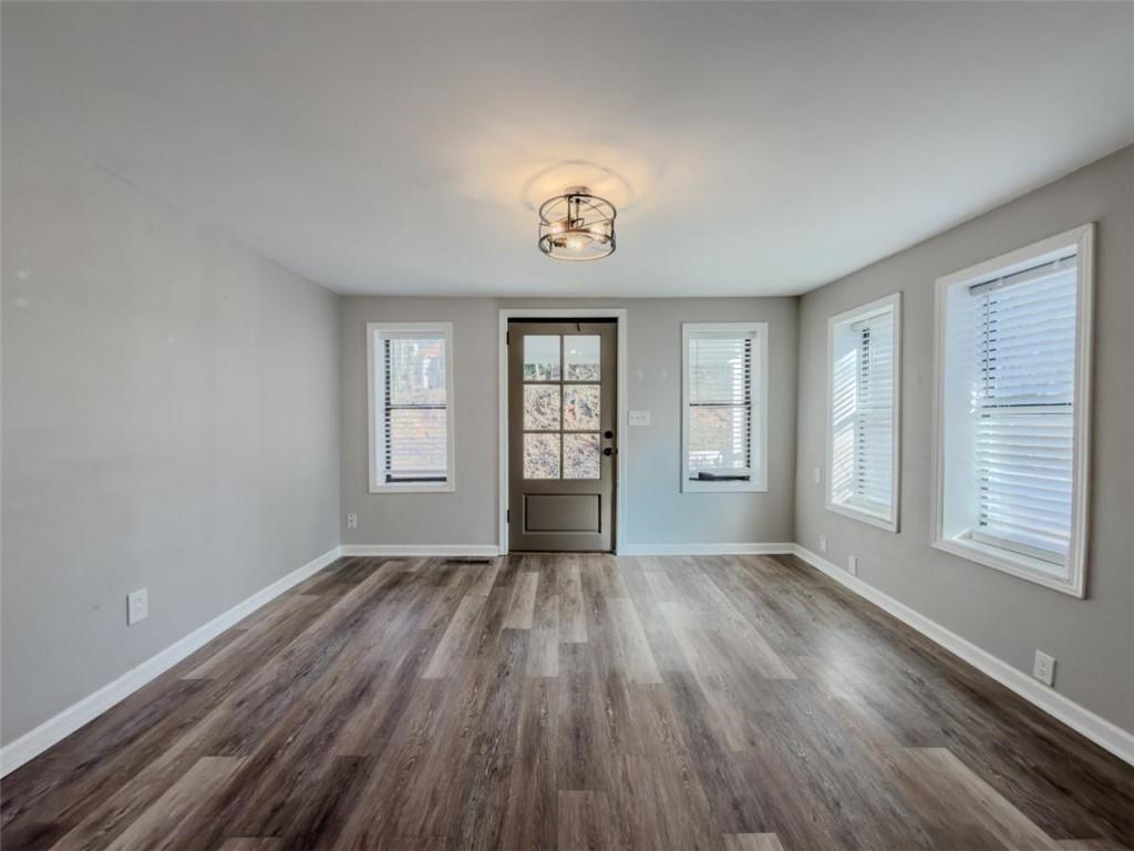 2317 Ford White Road Gainesville, GA 30506 - Photo 2 of 27 a view of an empty room with wooden floor and a window
