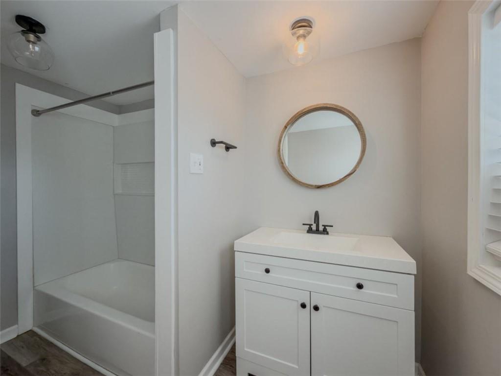 2317 Ford White Road Gainesville, GA 30506 - Photo 4 of 27 a bathroom with a sink a bathtub and a shower