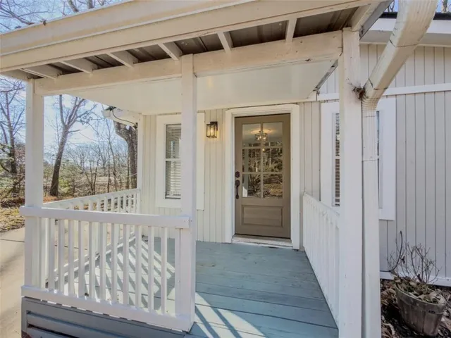 a view of a hallway with wooden floor and windows