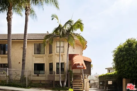 a view of a house with a palm tree
