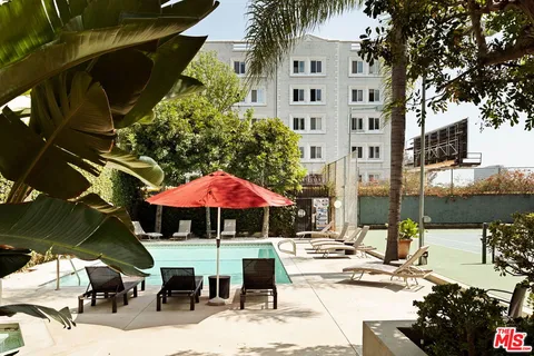 a view of a patio with a table and chairs under an umbrella