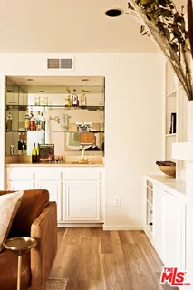 a living room with stainless steel appliances kitchen island granite countertop a refrigerator and a stove
