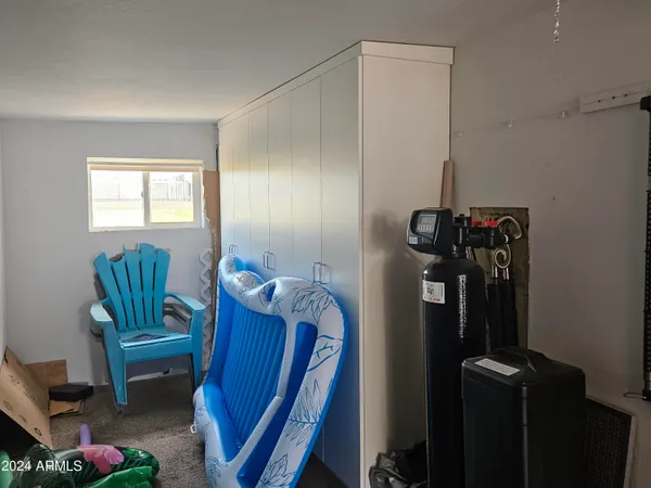 a view of hallway with furniture and a window