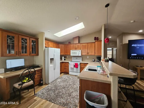a open kitchen with stainless steel appliances granite countertop a barbecue kitchen island a stove and a sink
