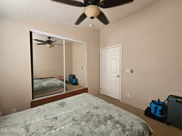 a view of a hallway with wooden floor and closet