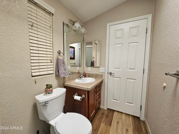 a bathroom with a sink a toilet and a mirror