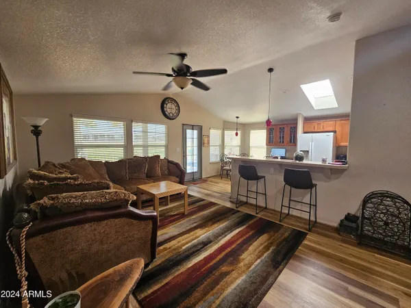 a living room with furniture a chandelier and a piano