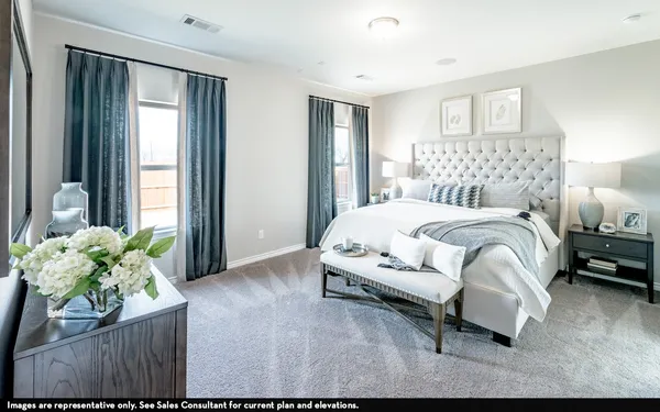 a bedroom with a bed table and a couch