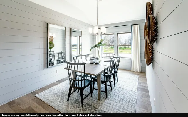 a view of a dining room with furniture wooden floor and a chandelier