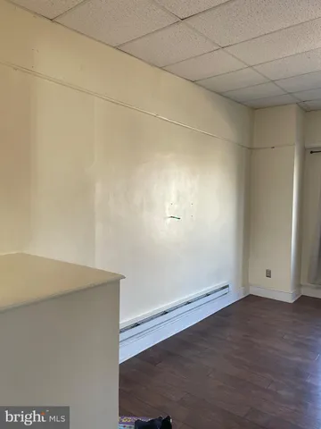 an empty room with wooden floor