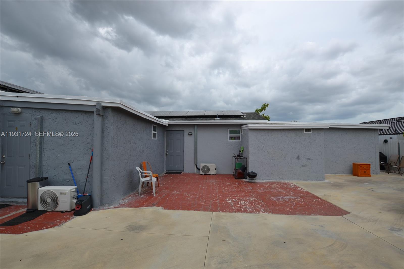 12374 Southwest 197th Terrace Miami, FL 33177 - Photo 16 of 18 a backyard of a house with barbeque oven and outdoor seating
