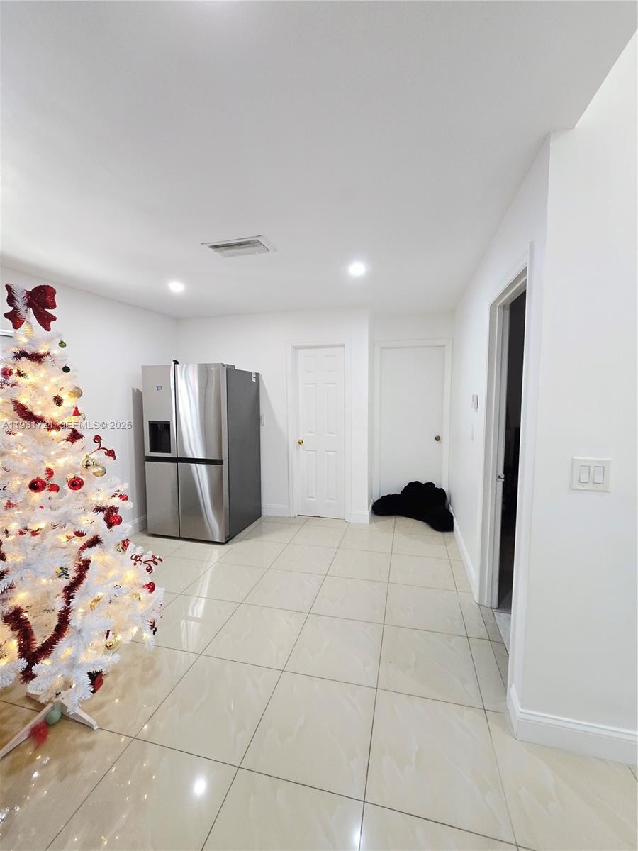 12374 Southwest 197th Terrace Miami, FL 33177 - Photo 5 of 18 a view of kitchen with refrigerator and white cabinets