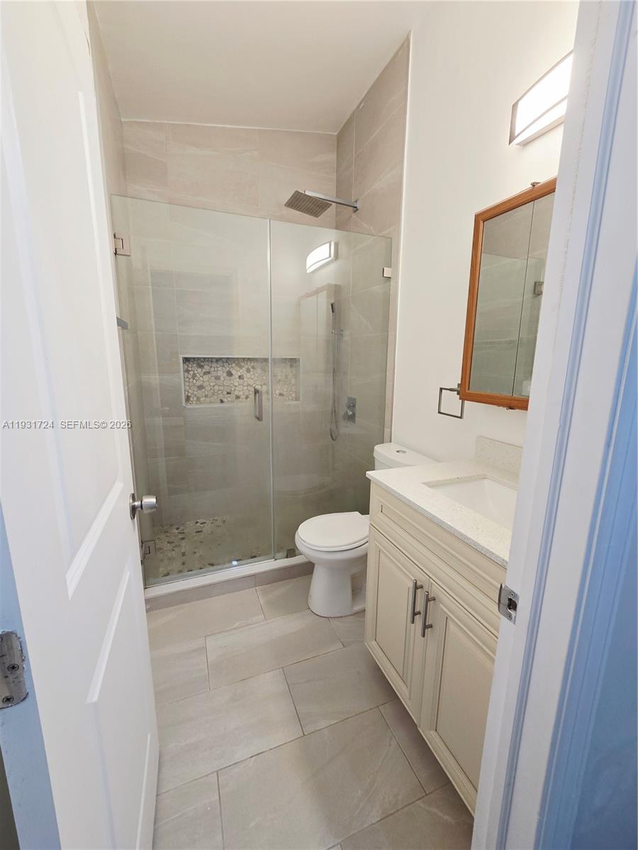 12374 Southwest 197th Terrace Miami, FL 33177 - Photo 8 of 18 a bathroom with a sink a toilet and shower