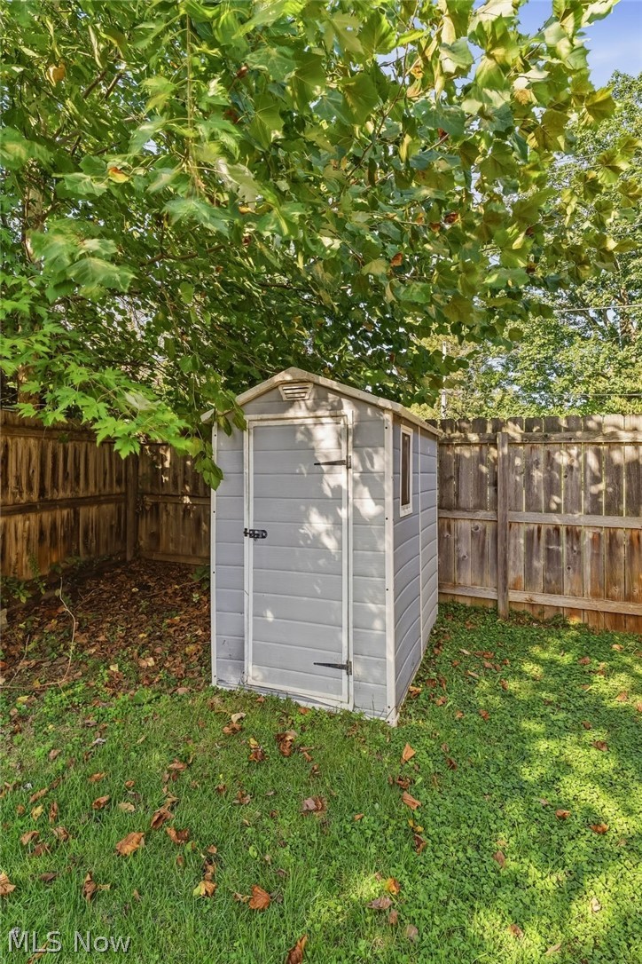 4619 Ridge Avenue Southeast Canton, OH 44707 - Photo 26 of 26 Enclosed backyard with a storage shed, wood fencing, and mature trees
