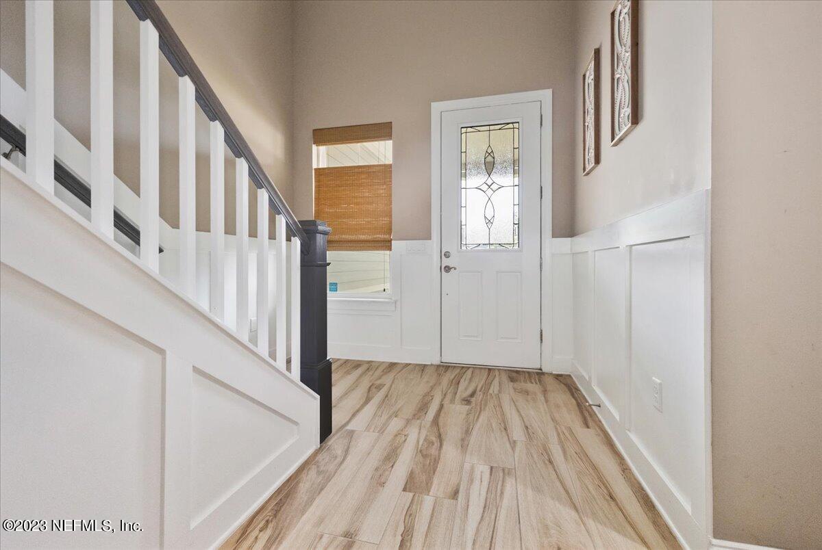 39 Seahill Drive St. Augustine, FL 32092 - Photo 4 of 37 a view of a hallway with wooden floor and staircase