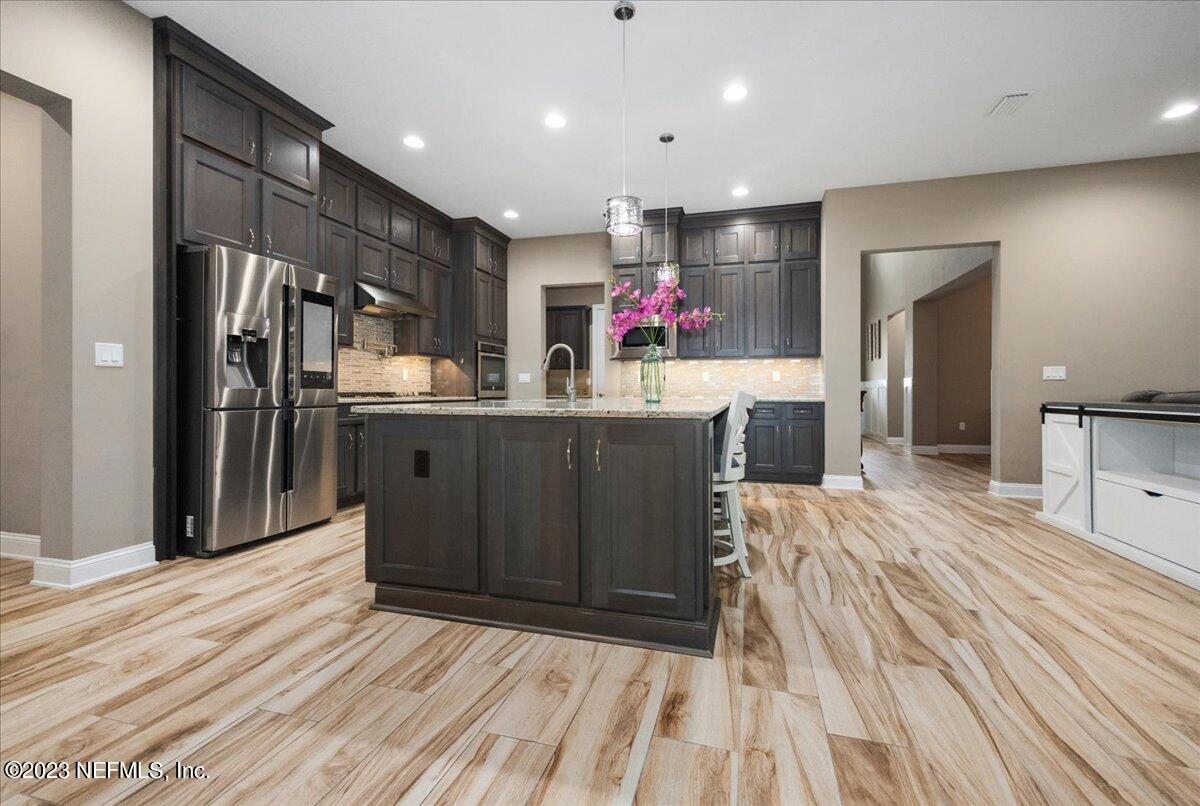 39 Seahill Drive St. Augustine, FL 32092 - Photo 9 of 37 a kitchen with granite countertop a refrigerator and a sink