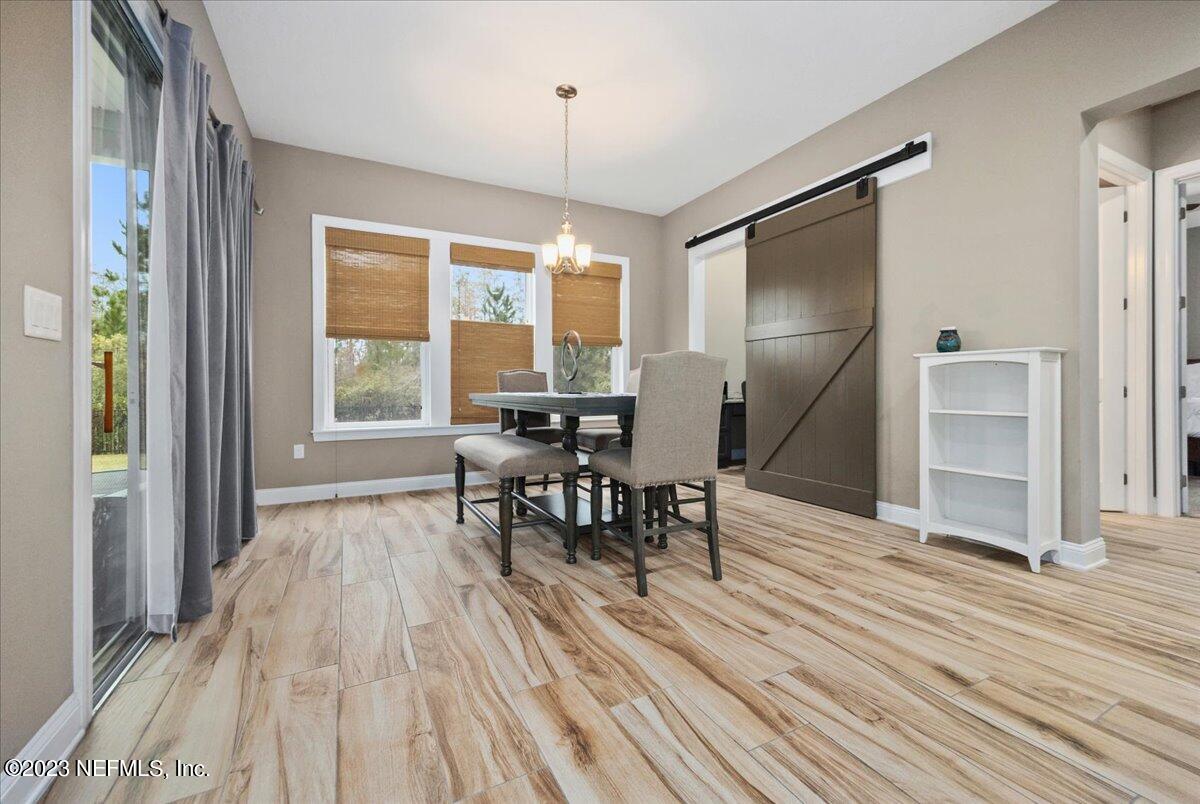 39 Seahill Drive St. Augustine, FL 32092 - Photo 10 of 37 a view of a dining room with furniture window and wooden floor