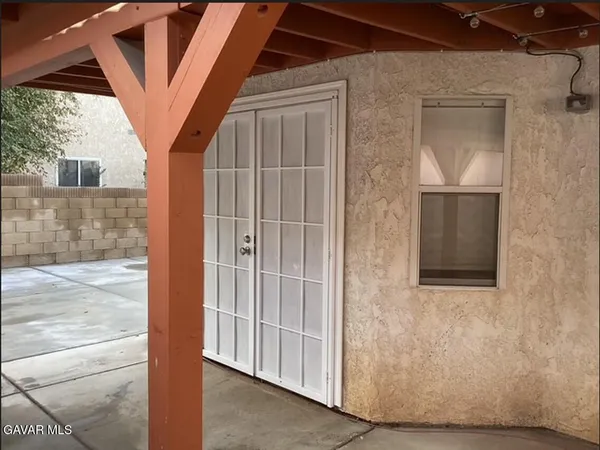 a bedroom with a bed and a mirror