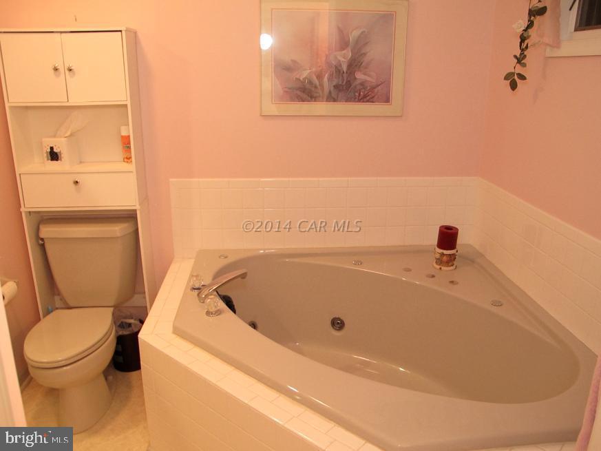 35 Falcon Bridge Road Berlin, MD 21811 - Photo 14 of 21 a bathroom with a white toilet and a sink
