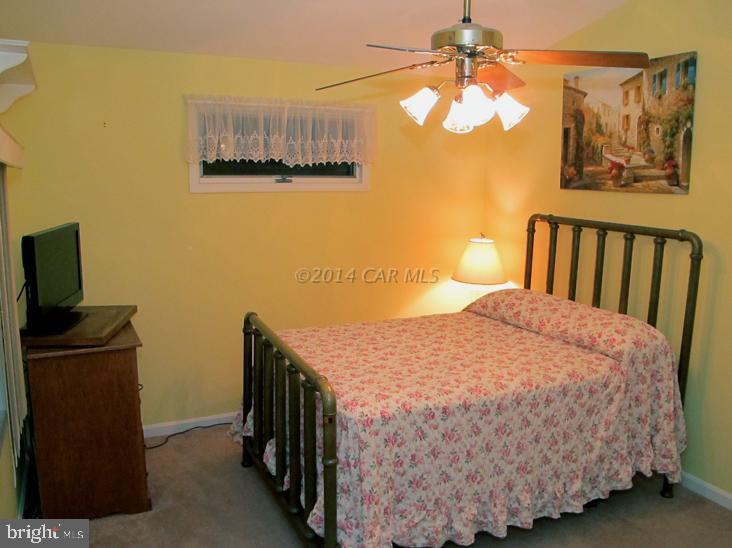 35 Falcon Bridge Road Berlin, MD 21811 - Photo 16 of 21 a bedroom with a bed and a chandelier
