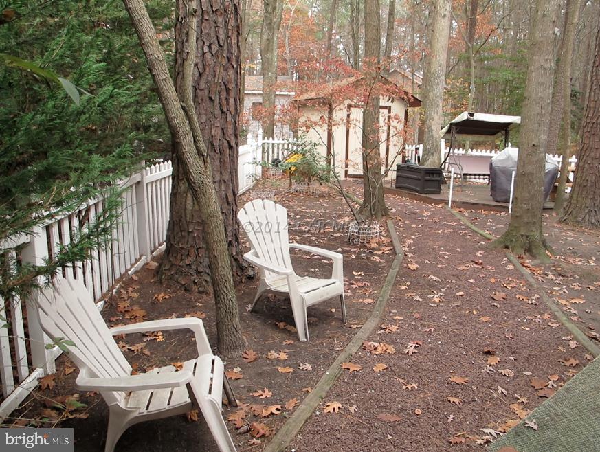 35 Falcon Bridge Road Berlin, MD 21811 - Photo 20 of 21 a view of a patio with a table chairs and a backyard