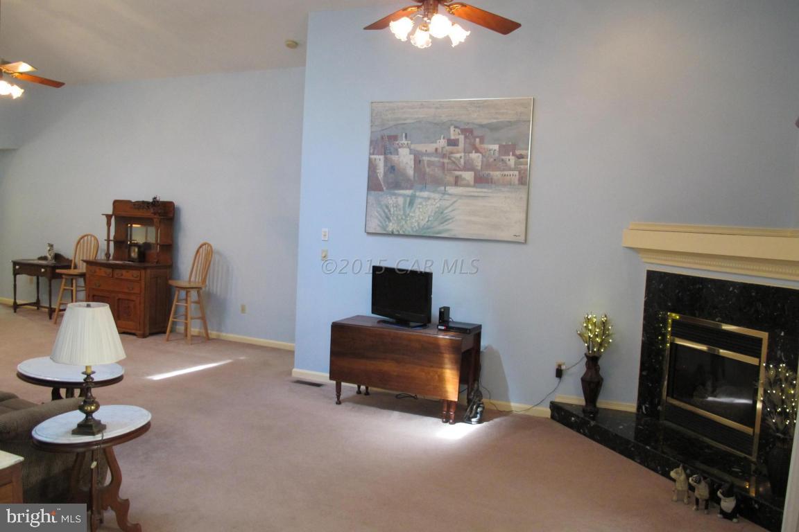 35 Falcon Bridge Road Berlin, MD 21811 - Photo 4 of 21 a living room with furniture and a fireplace