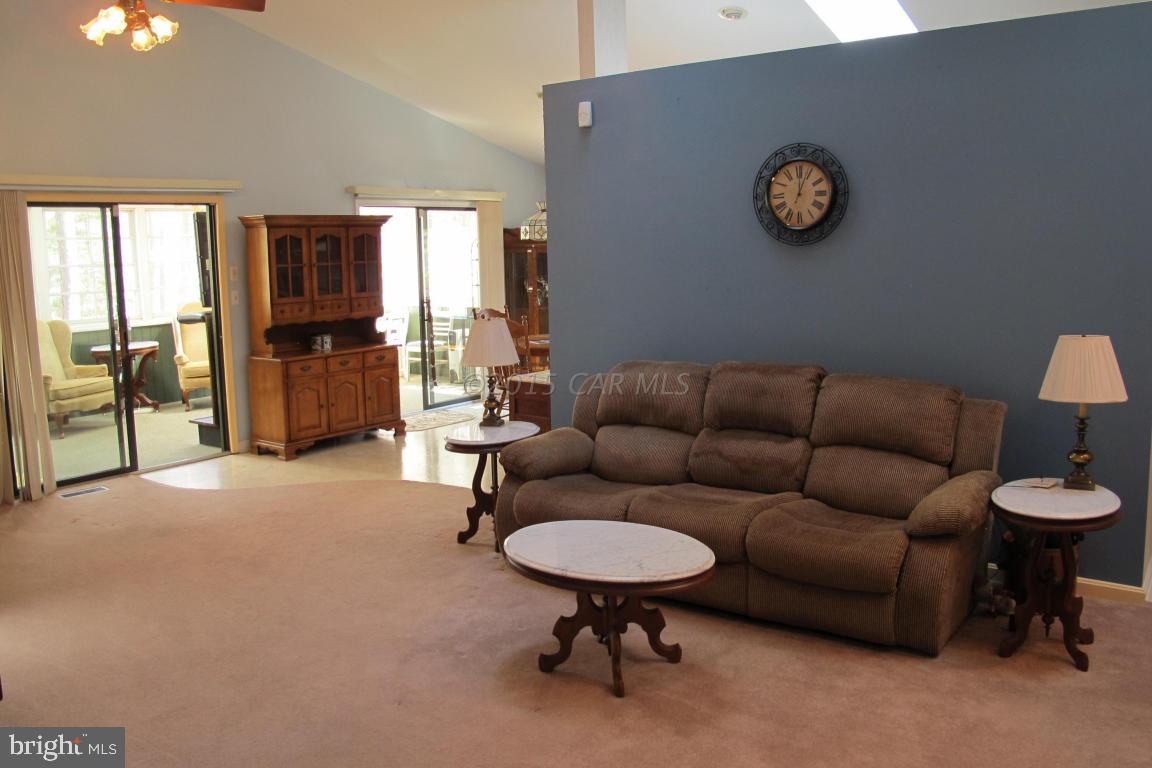 35 Falcon Bridge Road Berlin, MD 21811 - Photo 5 of 21 a living room with furniture a rug and a wall painting