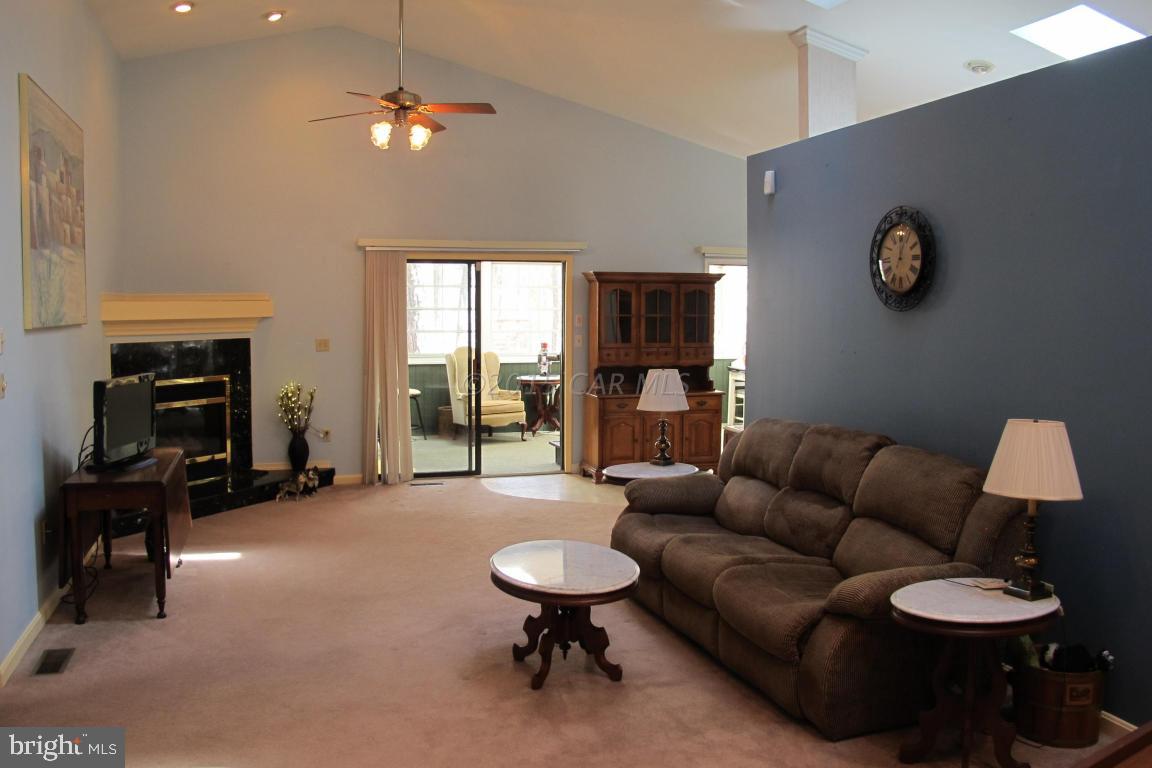 35 Falcon Bridge Road Berlin, MD 21811 - Photo 6 of 21 a living room with furniture a fireplace and a flat screen tv