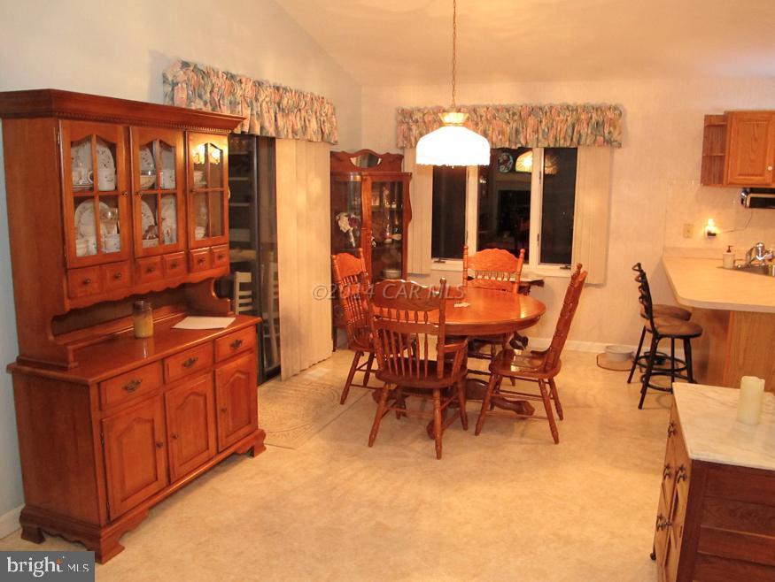35 Falcon Bridge Road Berlin, MD 21811 - Photo 7 of 21 a view of a dining room with furniture