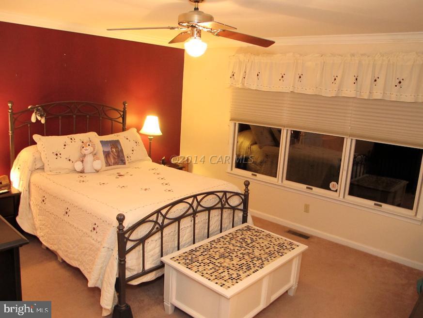 35 Falcon Bridge Road Berlin, MD 21811 - Photo 10 of 21 a bedroom with bed and cabinets